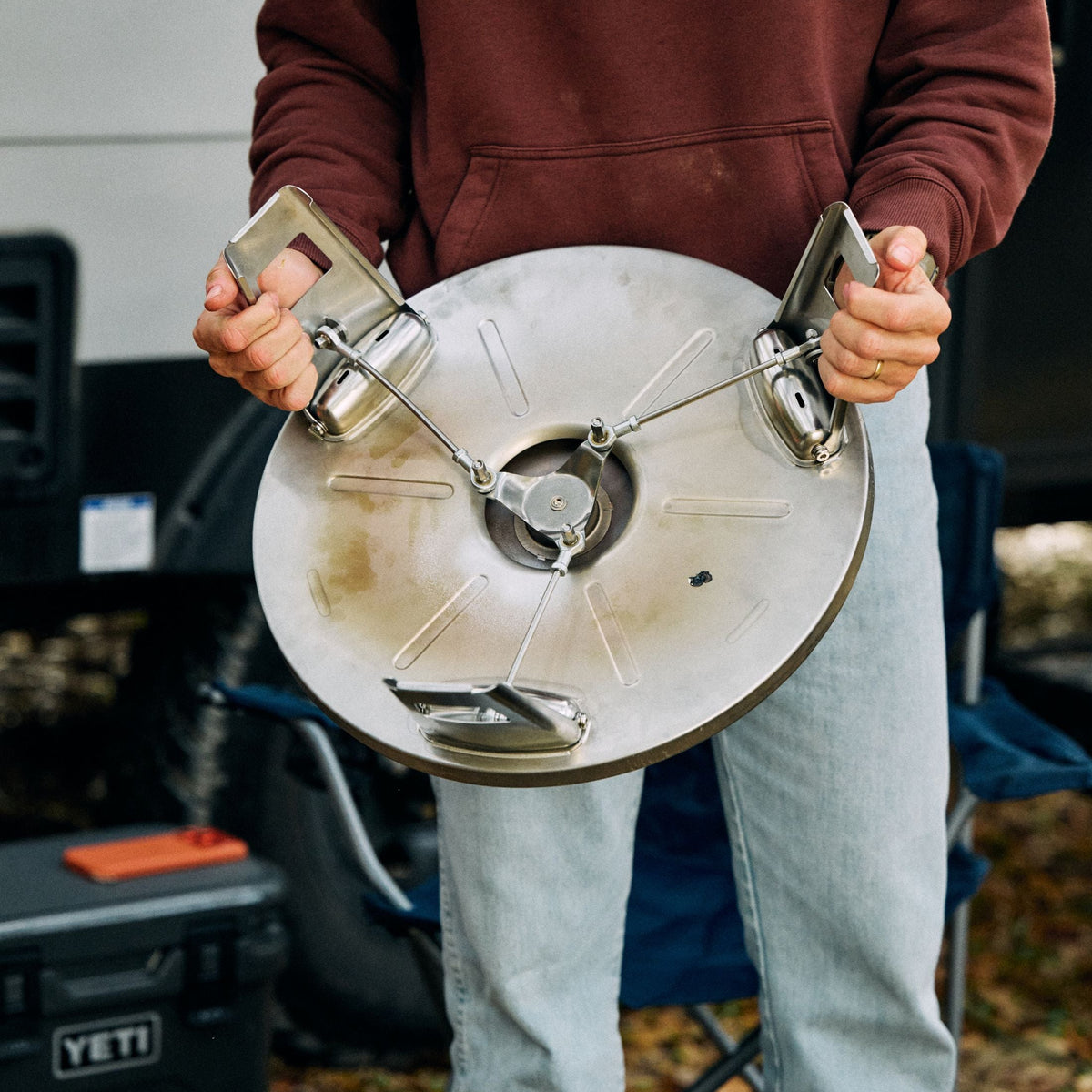 A man expanding the packfire foldable fire pit base 